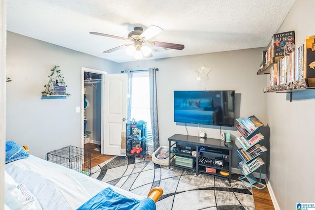 736 Buena Vista Loop, Prattville, AL 36067 - bedroom featuring wood finished floors, a textured ceiling, ceiling fan, a spacious closet, and a closet