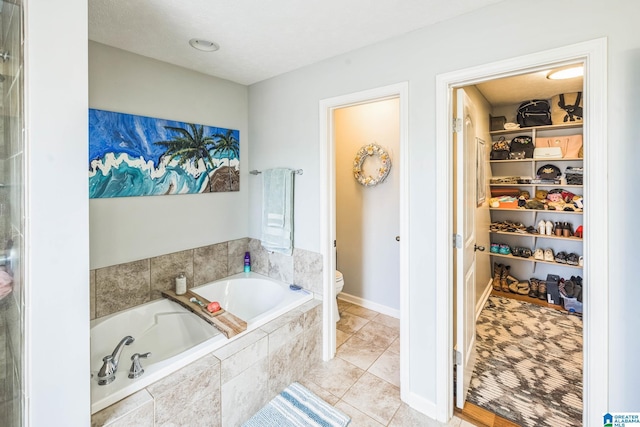 736 Buena Vista Loop, Prattville, AL 36067 - bathroom with toilet, a bath, a walk in closet, and tile patterned flooring