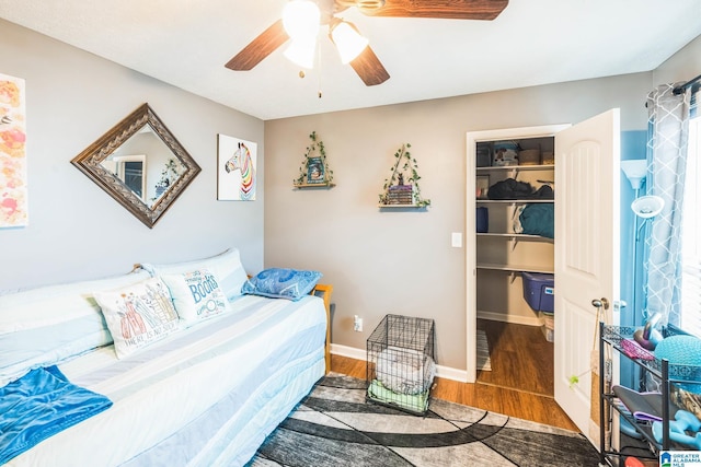 736 Buena Vista Loop, Prattville, AL 36067 - bedroom featuring a walk in closet, wood finished floors, ceiling fan, a closet, and baseboards