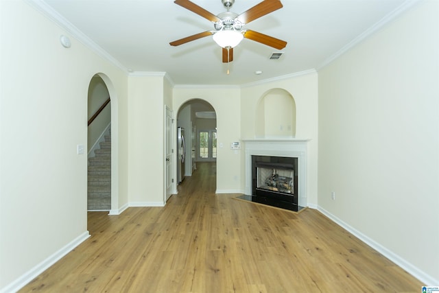 2449 Ridgemont Dr, Birmingham, AL 35244 - unfurnished living room featuring a fireplace, light wood-style floors, a ceiling fan, arched walkways, and stairway