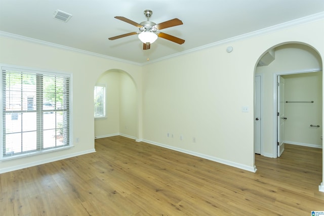 2449 Ridgemont Dr, Birmingham, AL 35244 - empty room with arched walkways, crown molding, a ceiling fan, baseboards, and light wood finished floors
