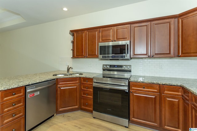 2449 Ridgemont Dr, Birmingham, AL 35244 - kitchen featuring stainless steel appliances, a sink, light stone counters, decorative backsplash, and recessed lighting