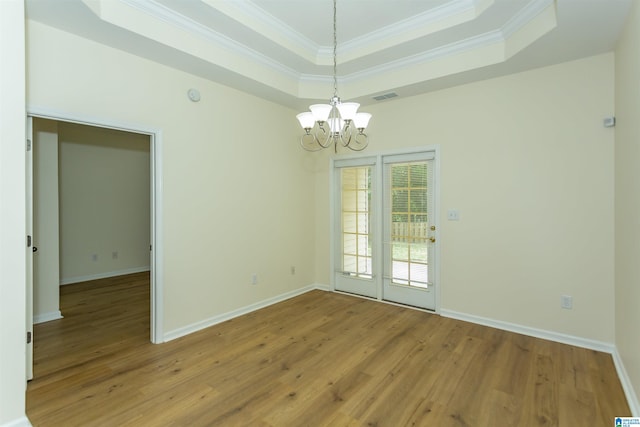 2449 Ridgemont Dr, Birmingham, AL 35244 - unfurnished room with a chandelier, a tray ceiling, light wood finished floors, crown molding, and baseboards