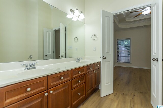 2449 Ridgemont Dr, Birmingham, AL 35244 - bathroom featuring ornamental molding, double vanity, wood finished floors, ceiling fan, and a raised ceiling
