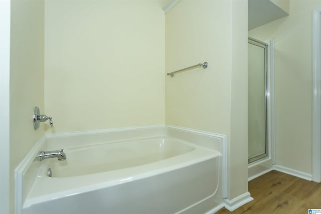 2449 Ridgemont Dr, Birmingham, AL 35244 - bathroom featuring a garden tub, a stall shower, wood finished floors, and baseboards