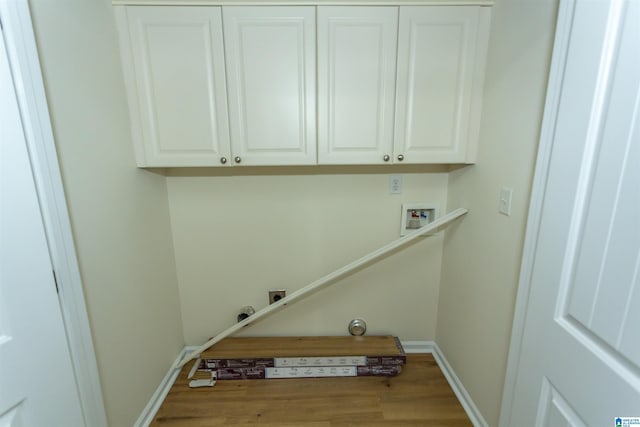 2449 Ridgemont Dr, Birmingham, AL 35244 - laundry area with cabinet space, wood finished floors, hookup for an electric dryer, hookup for a washing machine, and baseboards