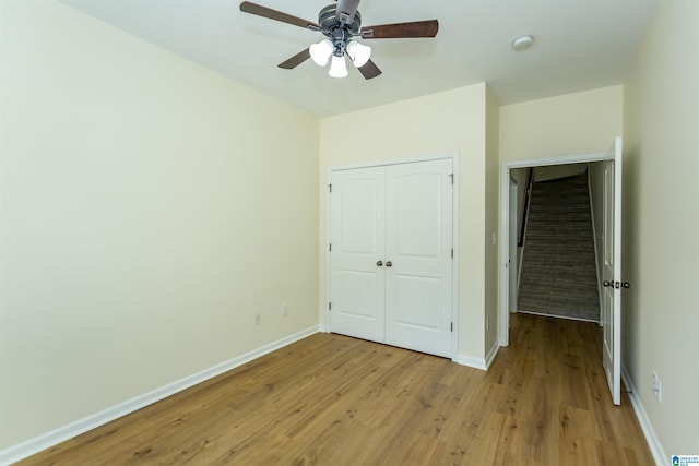 2449 Ridgemont Dr, Birmingham, AL 35244 - unfurnished bedroom featuring light wood-type flooring, baseboards, a closet, and ceiling fan