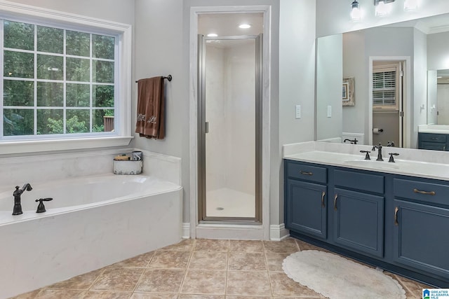 7805 Rock Creek Cir, Bessemer, AL 35023 - full bathroom featuring vanity, a shower stall, a garden tub, and healthy amount of natural light