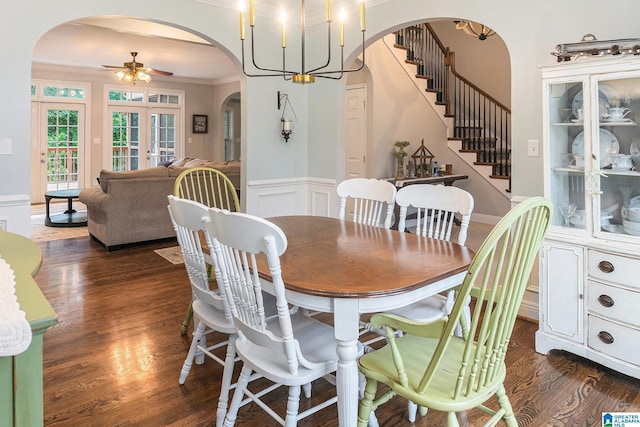 7805 Rock Creek Cir, Bessemer, AL 35023 - dining space with arched walkways, dark wood finished floors, ornamental molding, stairs, and a wainscoted wall