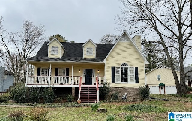 1121 Colonial Dr, Alabaster, AL 35007 - view of front of house with covered porch, stairway, a detached garage, and a chimney