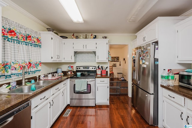1121 Colonial Dr, Alabaster, AL 35007 - kitchen featuring appliances with stainless steel finishes, dark wood finished floors, white cabinetry, a sink, and dark countertops