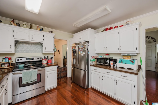 1121 Colonial Dr, Alabaster, AL 35007 - kitchen featuring stainless steel appliances, dark countertops, white cabinets, crown molding, and dark wood-type flooring