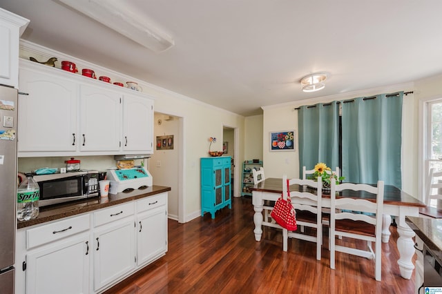 1121 Colonial Dr, Alabaster, AL 35007 - dining room featuring dark wood-style flooring, crown molding, and baseboards