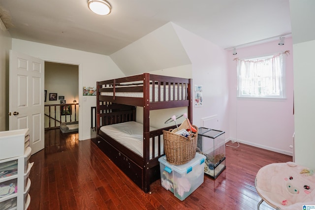 1121 Colonial Dr, Alabaster, AL 35007 - bedroom featuring hardwood / wood-style flooring, baseboards, rail lighting, and vaulted ceiling
