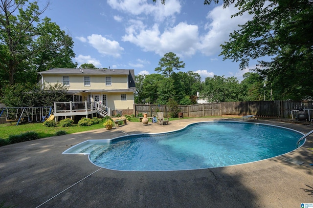 1121 Colonial Dr, Alabaster, AL 35007 - view of swimming pool with a fenced backyard, a patio area, a deck, and a playground