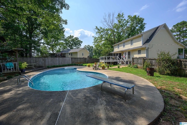 1121 Colonial Dr, Alabaster, AL 35007 - view of swimming pool with a wooden deck, a fenced backyard, a patio area, and a diving board