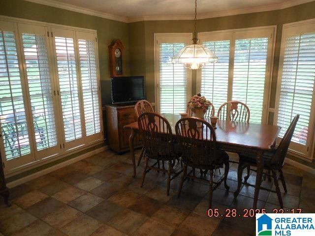 222 Odum Crest Ln, Hoover, AL 35226 - dining space featuring plenty of natural light, a chandelier, stone finish floors, and crown molding