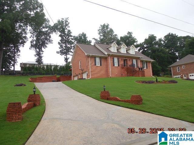 222 Odum Crest Ln, Hoover, AL 35226 - cape cod home featuring driveway, brick siding, and a front lawn