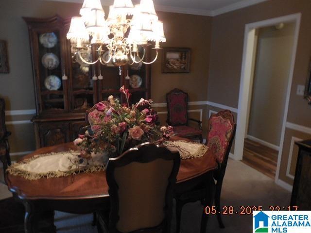 222 Odum Crest Ln, Hoover, AL 35226 - dining area featuring a chandelier, crown molding, and wood finished floors