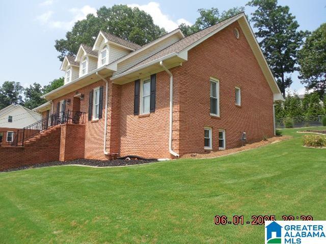 222 Odum Crest Ln, Hoover, AL 35226 - view of home's exterior with a lawn, brick siding, and stairs