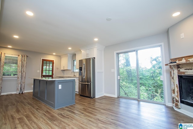 3501 Pineland Dr, Birmingham, AL 35243 - kitchen with stainless steel refrigerator with ice dispenser, a kitchen island, light countertops, white cabinetry, and dark wood finished floors