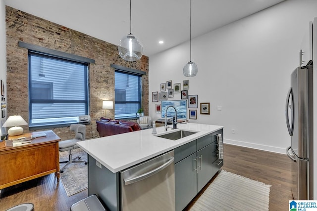 1801 2nd Ave N Unit 309, Birmingham, AL 35203 - kitchen featuring appliances with stainless steel finishes, a sink, open floor plan, an island with sink, and light countertops