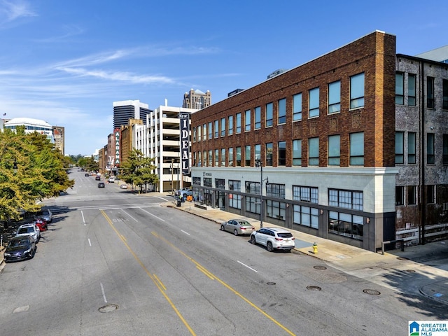 1801 2nd Ave N Unit 309, Birmingham, AL 35203 - view of building exterior with uncovered parking and a city view