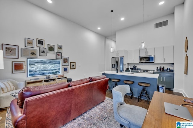 1801 2nd Ave N Unit 309, Birmingham, AL 35203 - living room with dark wood-style floors, recessed lighting, and a towering ceiling