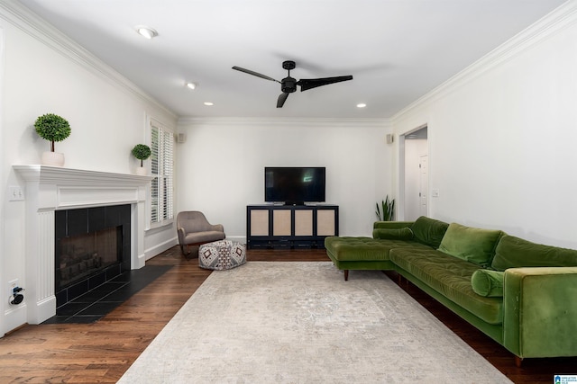 2032 Forest Meadows Cir, Birmingham, AL 35242 - living area with dark wood finished floors, a ceiling fan, a tiled fireplace, ornamental molding, and recessed lighting