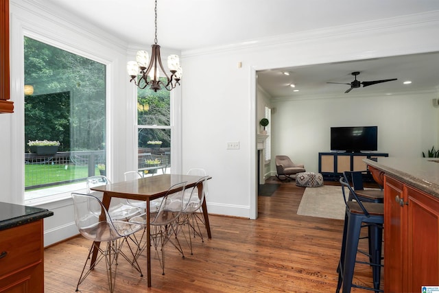 2032 Forest Meadows Cir, Birmingham, AL 35242 - dining area with dark wood-style floors, a chandelier, ornamental molding, ceiling fan, and a fireplace