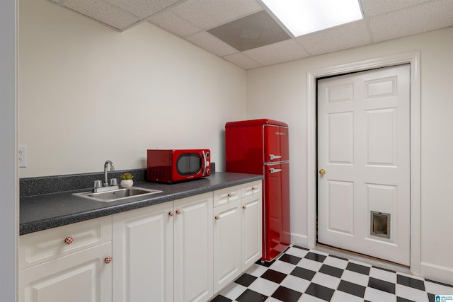 2032 Forest Meadows Cir, Birmingham, AL 35242 - kitchen featuring tile patterned floors, dark countertops, white cabinets, and a paneled ceiling