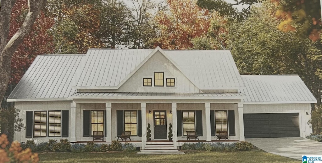 105 Barker St, Clanton, AL 35045 - view of front of property with a standing seam roof, covered porch, an attached garage, metal roof, and driveway