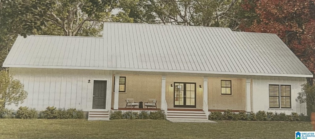 105 Barker St, Clanton, AL 35045 - view of front of house featuring a porch, a front lawn, and metal roof