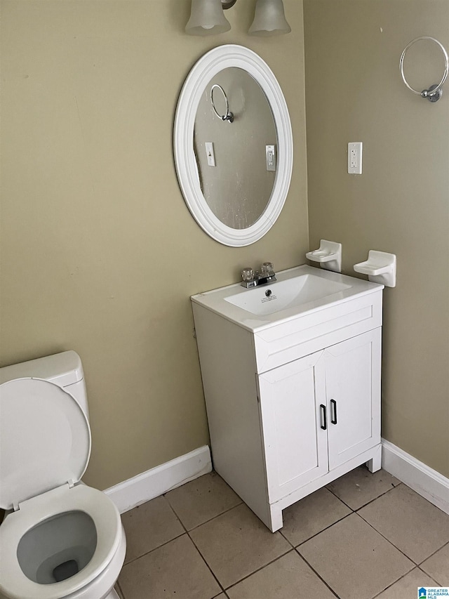 2408 Powderly Ave SW, Birmingham, AL 35211 - bathroom featuring tile patterned flooring, toilet, vanity, and baseboards