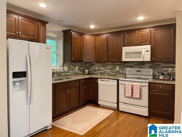 2213 Montreat Cir Unit D, Vestavia Hills, AL 35216 - kitchen featuring white appliances, tasteful backsplash, dark brown cabinets, wood finished floors, and recessed lighting