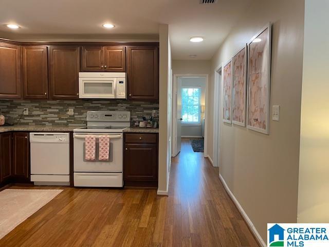 2213 Montreat Cir Unit D, Vestavia Hills, AL 35216 - kitchen featuring white appliances, wood finished floors, decorative backsplash, dark brown cabinets, and recessed lighting