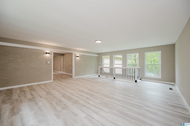 2016 NW 9th Pl, Center Point, AL 35215 - spare room featuring brick wall, baseboards, and light wood finished floors