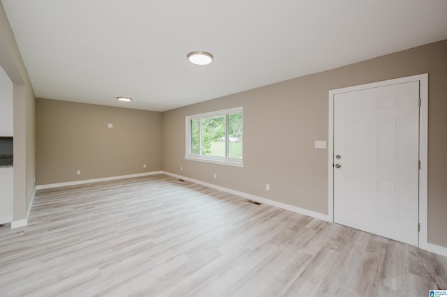 2016 NW 9th Pl, Center Point, AL 35215 - unfurnished living room with light wood-type flooring and baseboards