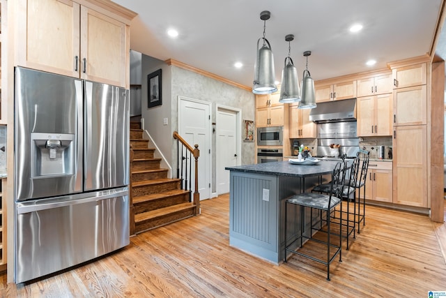 3420 Danner Cir, Vestavia Hills, AL 35243 - kitchen with stainless steel appliances, light brown cabinets, under cabinet range hood, light wood finished floors, and a center island