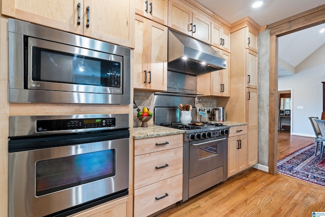 3420 Danner Cir, Vestavia Hills, AL 35243 - kitchen featuring appliances with stainless steel finishes, under cabinet range hood, light brown cabinets, light wood-type flooring, and light stone counters