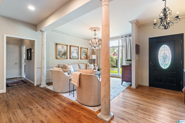 3420 Danner Cir, Vestavia Hills, AL 35243 - foyer entrance with decorative columns, a chandelier, wood finished floors, ornamental molding, and baseboards