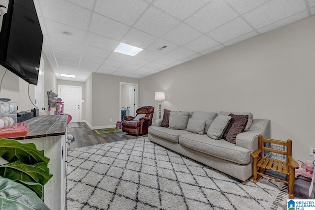 2597 Blake Way, Warrior, AL 35180 - living area featuring wood finished floors, a paneled ceiling, and baseboards