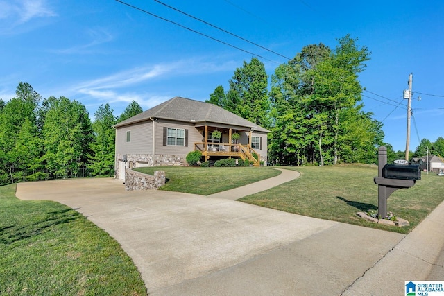 2597 Blake Way, Warrior, AL 35180 - view of front of property featuring concrete driveway, a front yard, an attached garage, and stone siding