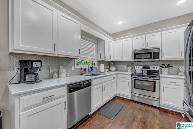 2597 Blake Way, Warrior, AL 35180 - kitchen featuring stainless steel appliances, a sink, white cabinets, dark wood-style flooring, and recessed lighting