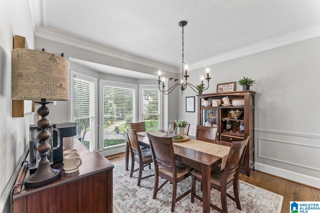 1505 Cypress Ln, Hoover, AL 35244 - dining space featuring a chandelier, wood finished floors, crown molding, wainscoting, and a decorative wall