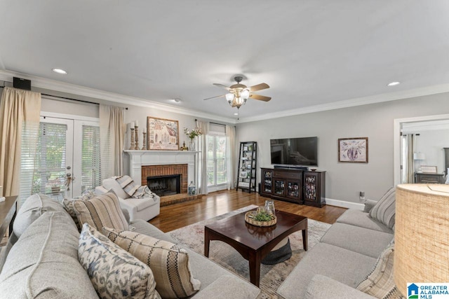 1505 Cypress Ln, Hoover, AL 35244 - living area featuring crown molding, ceiling fan, wood finished floors, a brick fireplace, and french doors