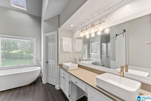 1505 Cypress Ln, Hoover, AL 35244 - bathroom featuring a freestanding bath, double vanity, a shower stall, and recessed lighting
