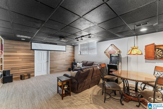 1505 Cypress Ln, Hoover, AL 35244 - carpeted living room featuring wood walls, rail lighting, and a drop ceiling