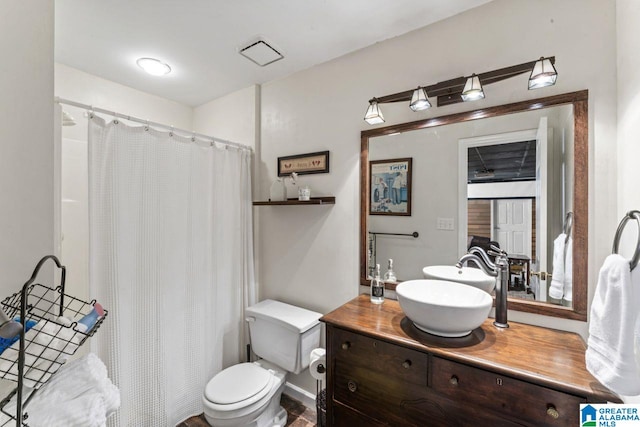 1505 Cypress Ln, Hoover, AL 35244 - full bathroom featuring vanity, toilet, and a shower with curtain