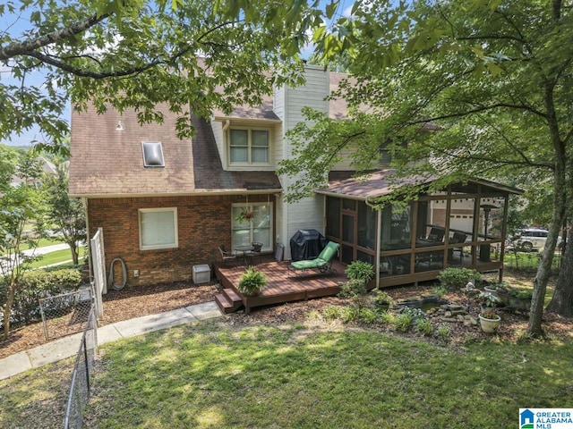 1505 Cypress Ln, Hoover, AL 35244 - back of house featuring a sunroom, a wooden deck, a chimney, brick siding, and a shingled roof